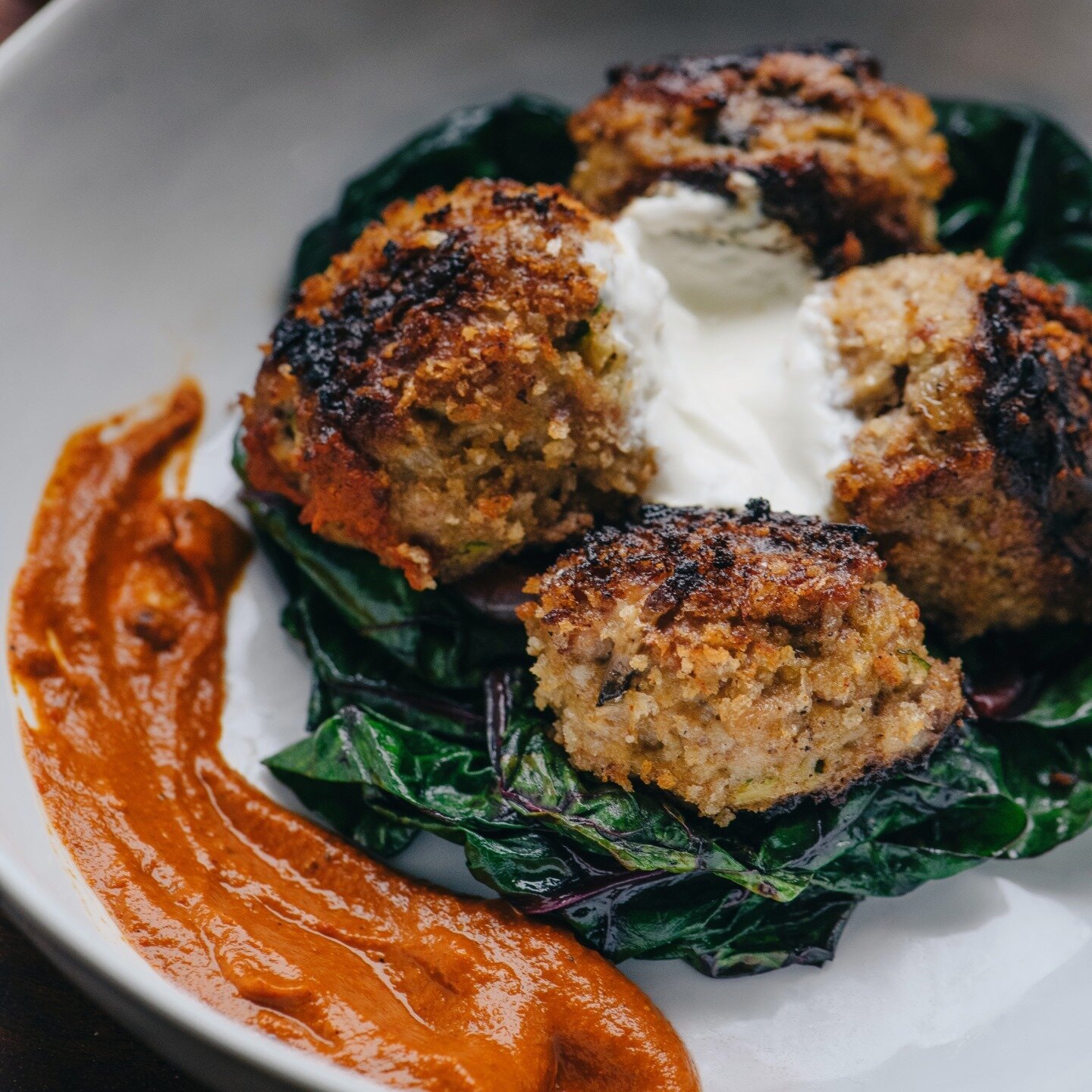 Albondigas De Cordero 
Lamb meatballs with roncal over wilted local arugula and pecan romesco topped with lemon sherry yogurt. Have you explored our tapas menu yet? Check it out via the link in our bio #laurelonrutledge